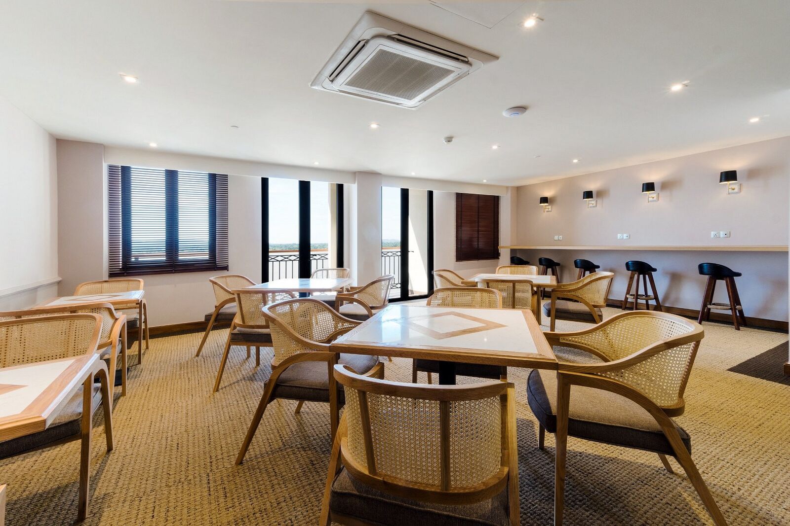 Lounge with cane chairs and a counter along the windows