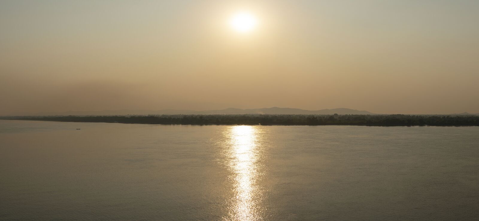 The Thanlwin River at sunset, with the sun reflected on the water